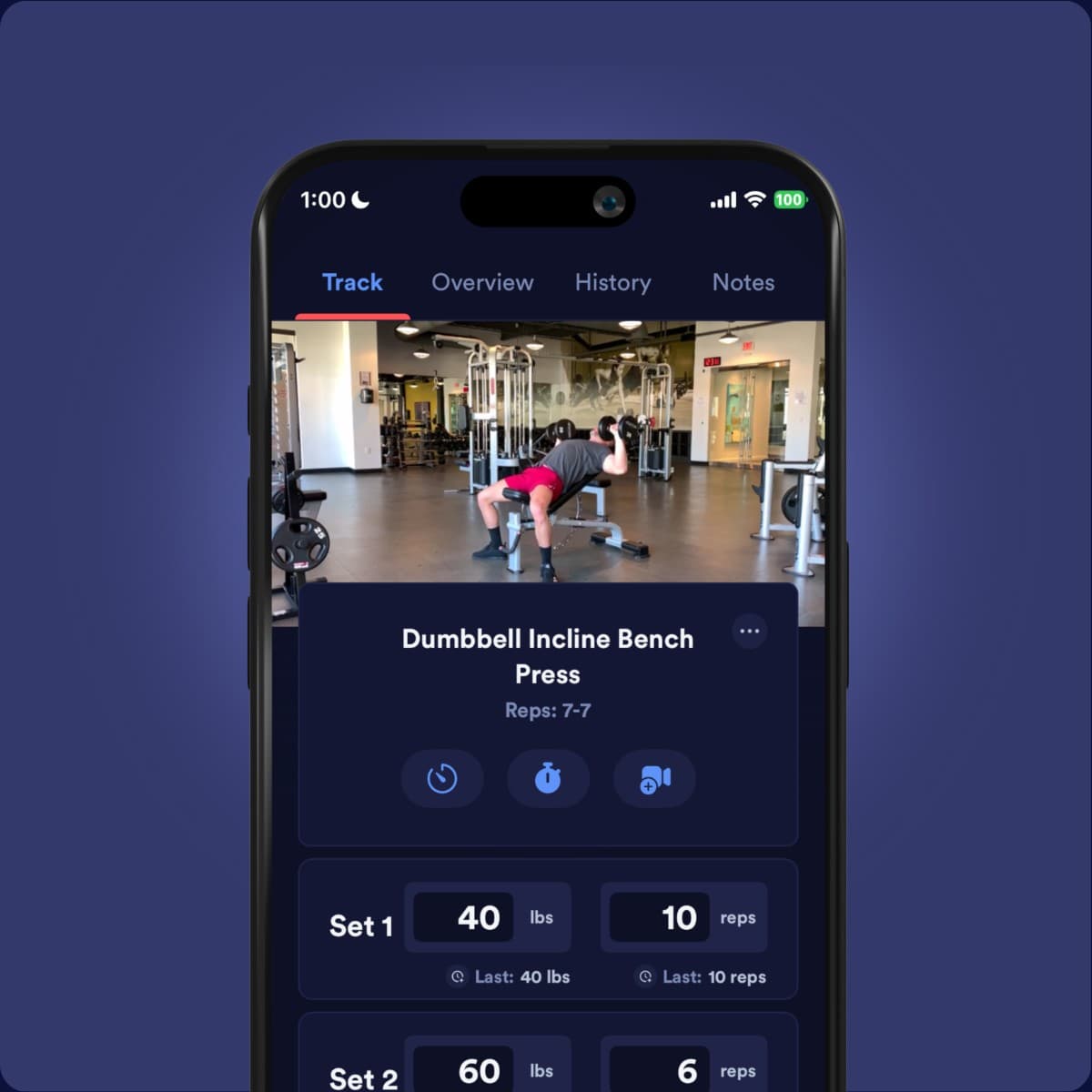 A phone showing the Caliber app's workout logging screen for a dumbbell incline bench press, with sets of weight and reps.