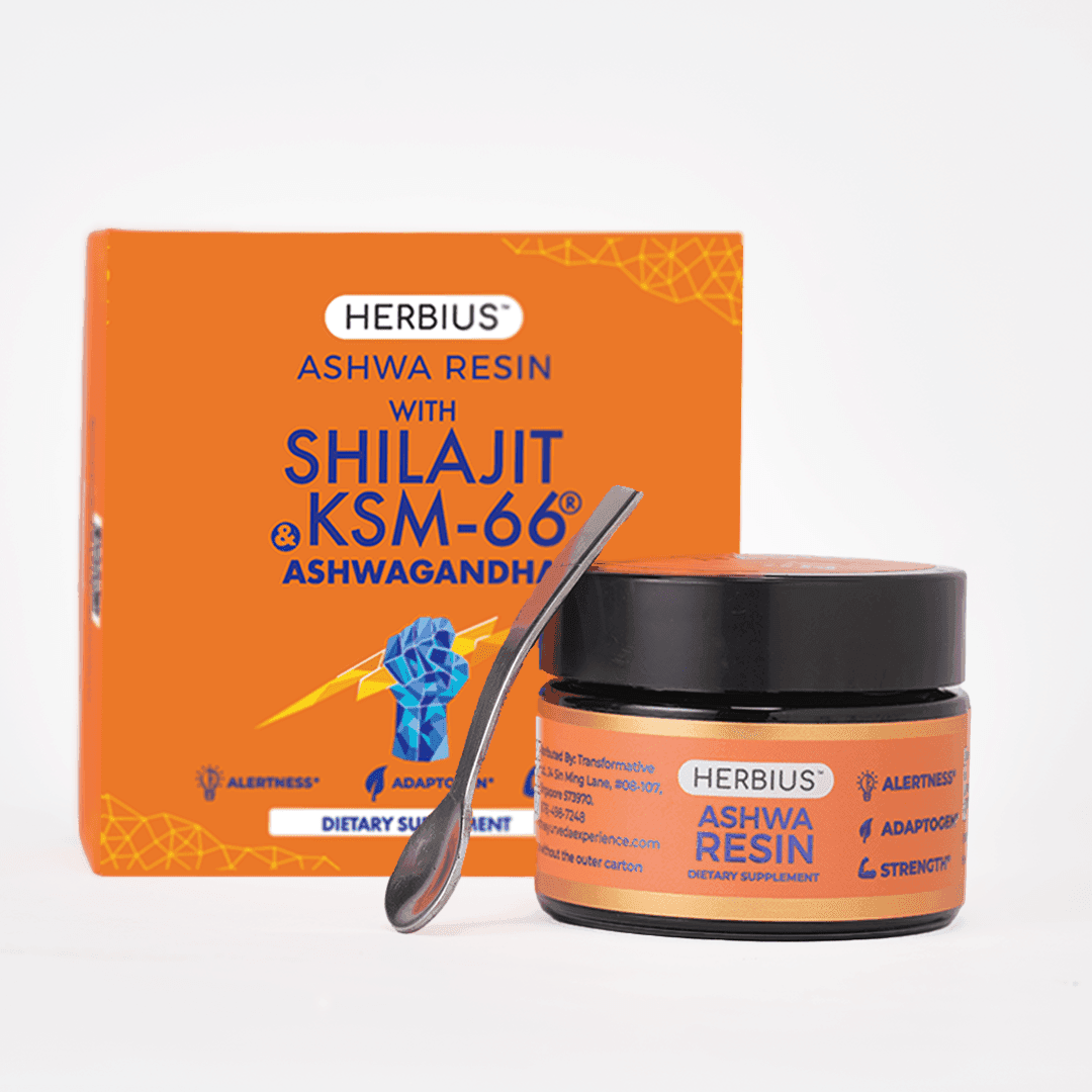 Orange Herbius Ashwa Resin carton standing behind a black lidded jar with an orange label, a metal spoon leaning against the jar, on a plain light grey background