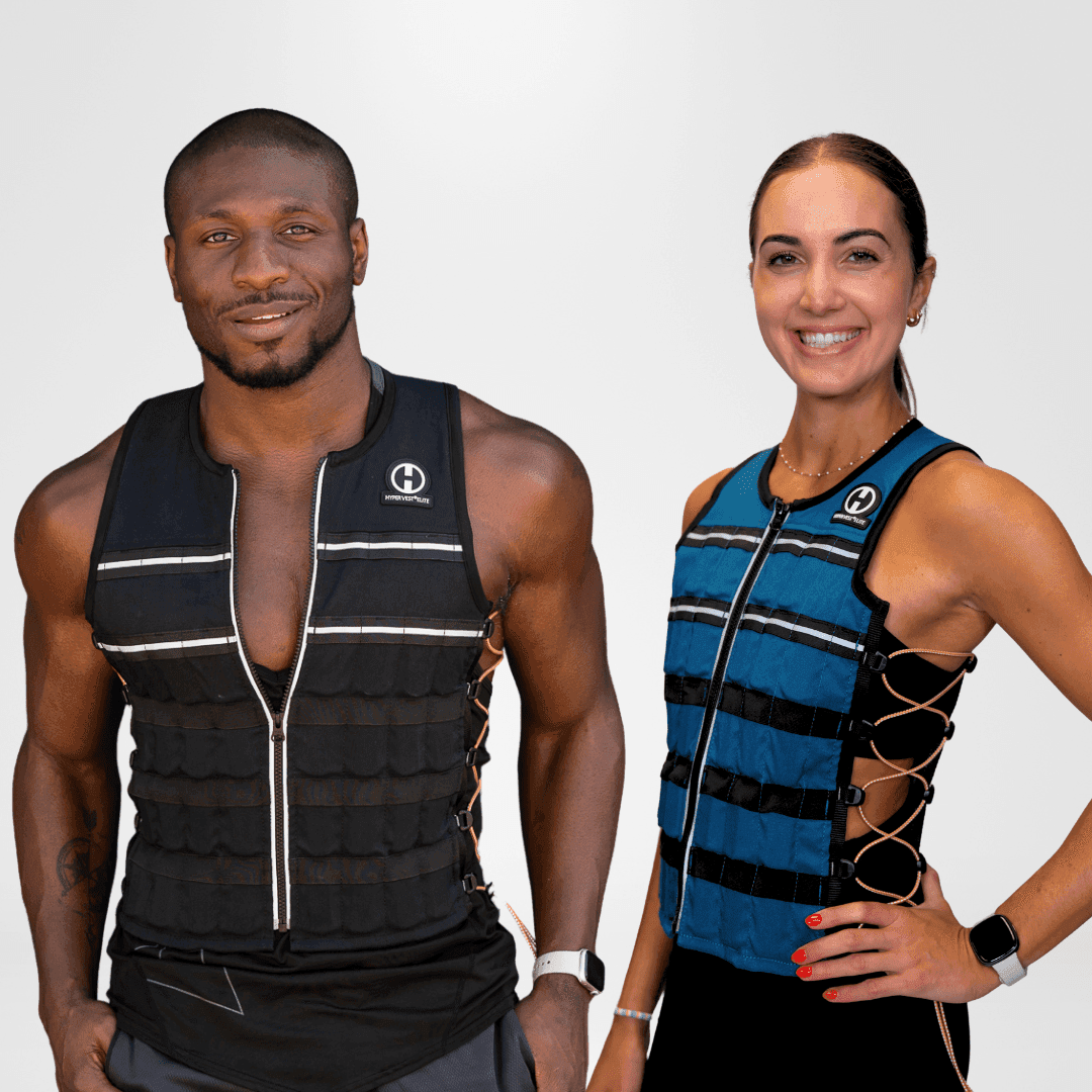 Hyperwear Hyper Vest ELITE weighted vest in black and in glacier blue, worn by two people on a plain grey background, with front zips, reflective strips and orange side lacing