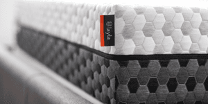 Layla Memory Foam Mattress on a bed frame showing its gray and white cover