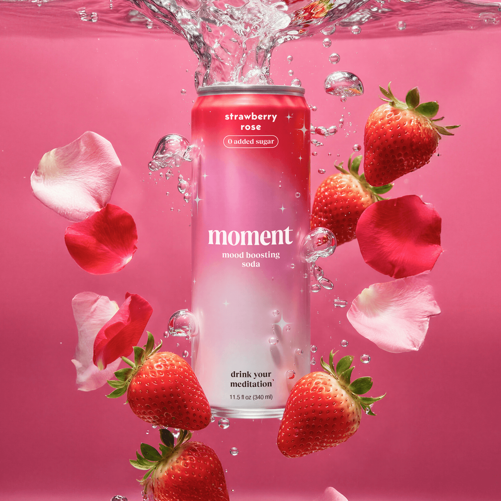 Moment Strawberry Rose 11.5 fl oz can standing in water with a splash at the top, surrounded by strawberries and rose petals on a pink background