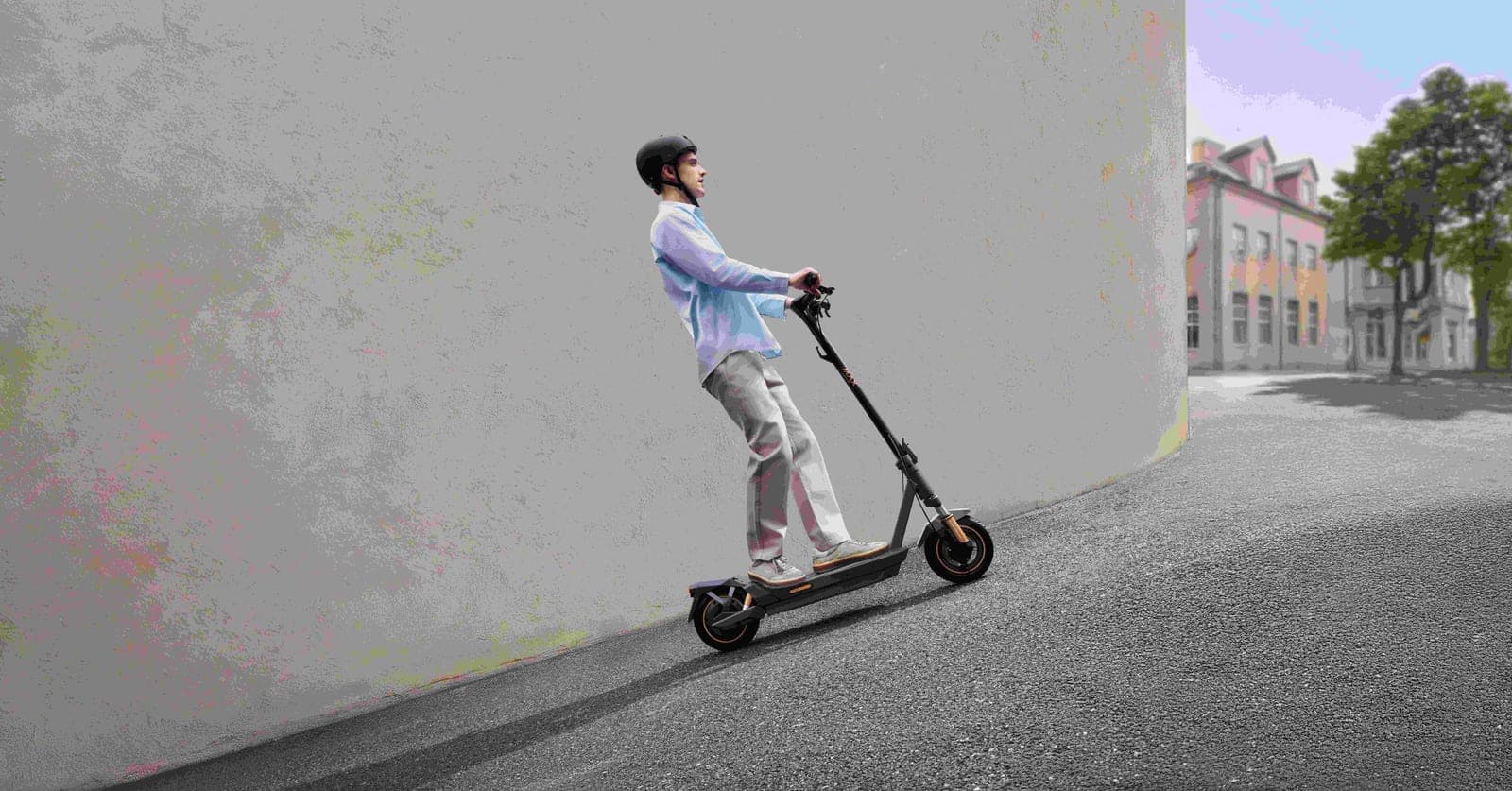 Navee GT5 Max electric scooter ridden up a city street, shown side on with the deck, folding stem and rear wheel visible against a plain wall