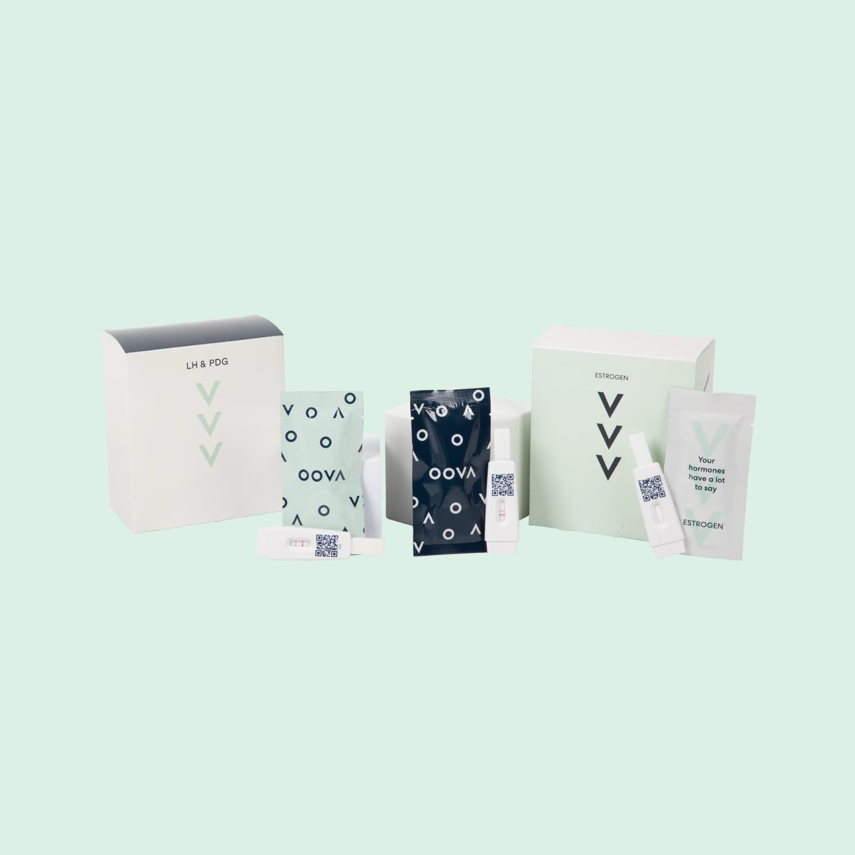 Oova Fertility Hormone Kit boxes with wrapped LH, PdG, and E3G urine test strips and test cassettes