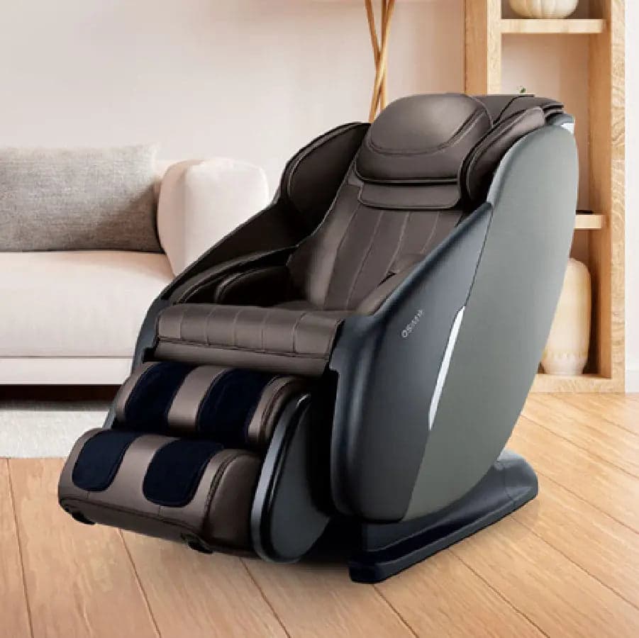OSIM uDeluxe Max massage chair in Brown with a dark grey outer shell, upright with its leg rest lowered, in a living room